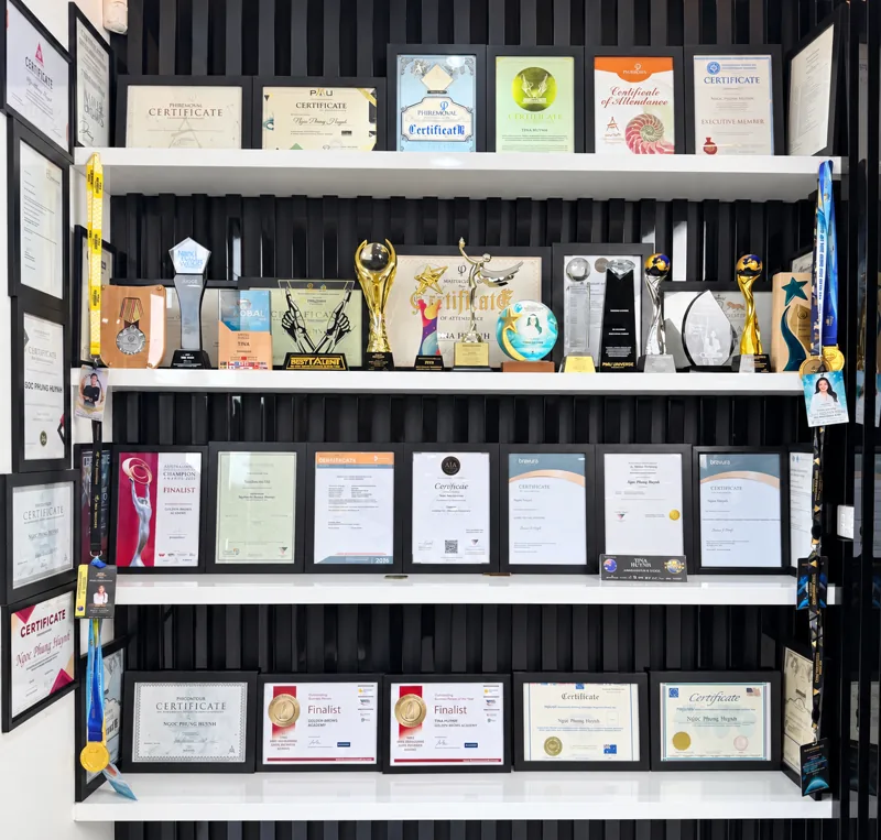 The awards and certificates cupboard at Golden Brows Academy