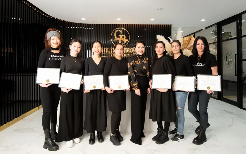 Graduates with their certificates at the academy