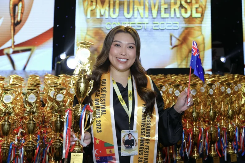Tina with the Australian flag as ambassador at PMU Universe 2023
